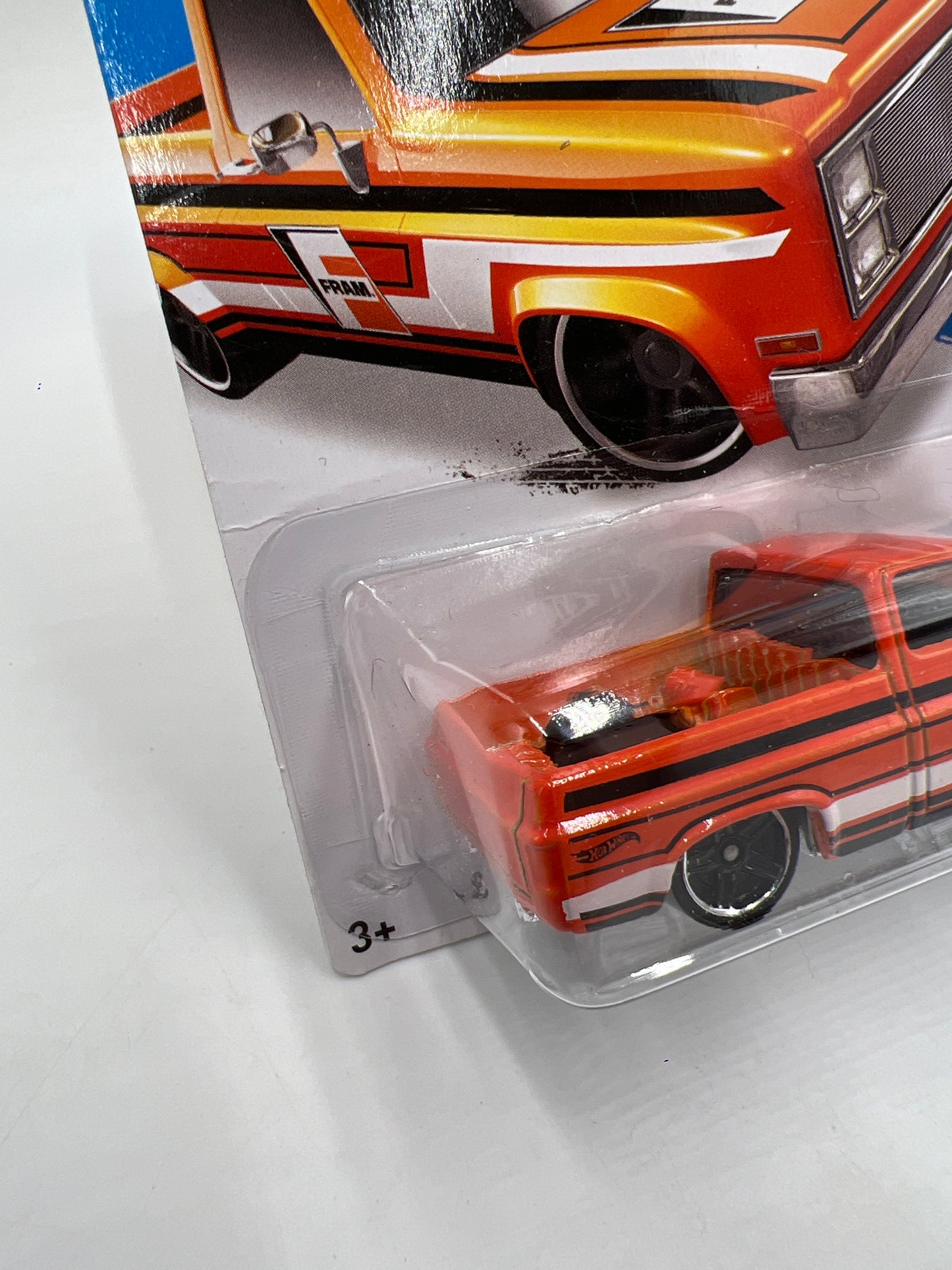 2015 Hot Wheels City #16 83 Chevy Silverado Fram Orange W/Protector Bad Card