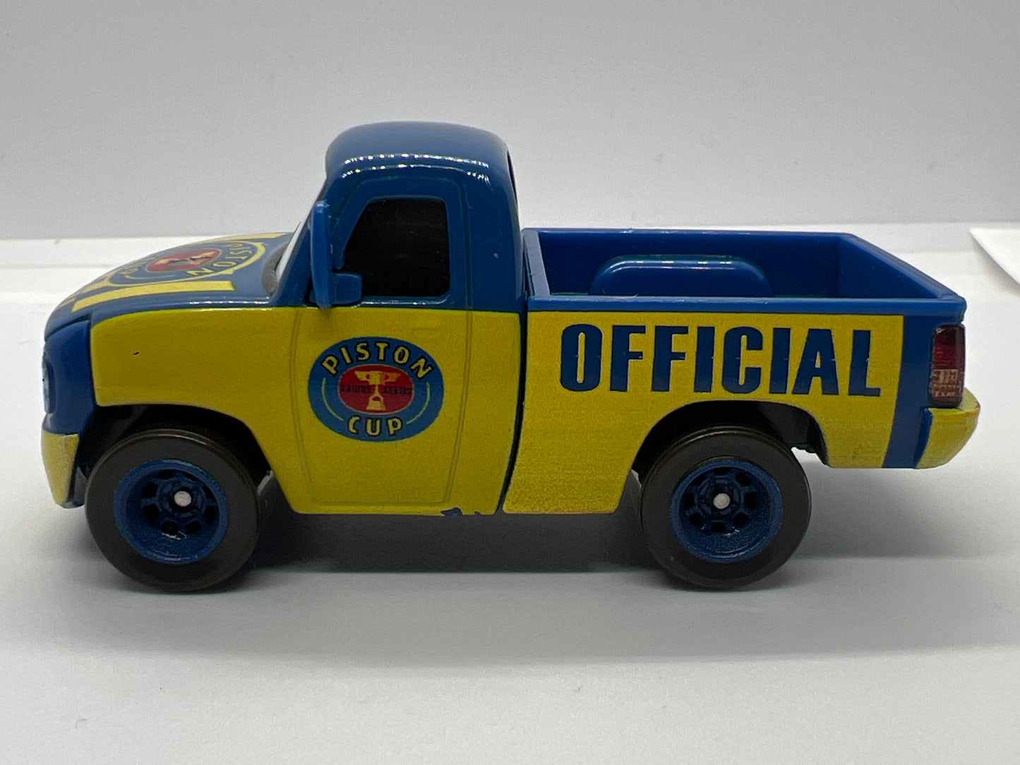 Disney Pixar Cars Piston Cup Race Tom Truck Blue/Yellow Loose