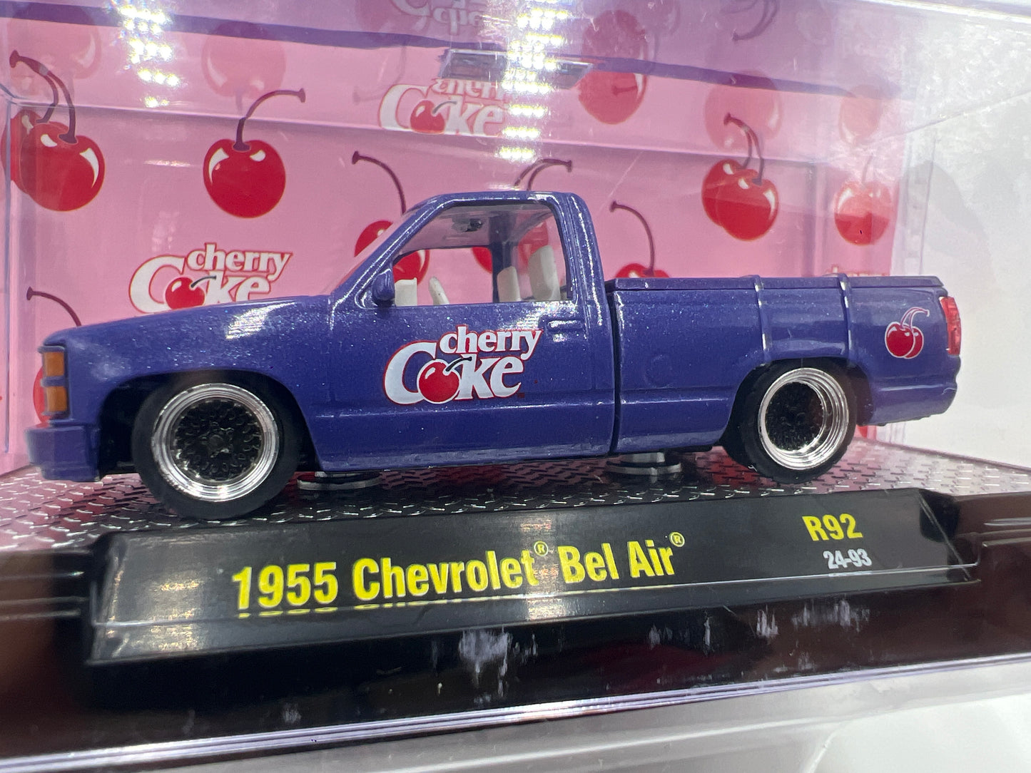 2024 M2 Machines Cherry Coke 1988 GMC Sierra 1500 Custom Purple Base Error (1955 Chevrolet Bel Air)