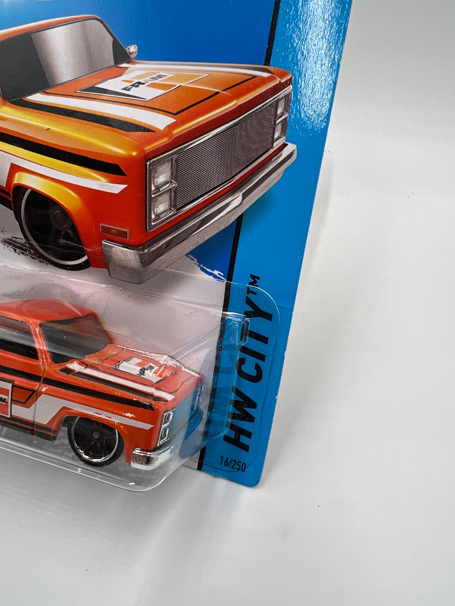 2015 Hot Wheels City #16 83 Chevy Silverado Fram Orange W/Protector Bad Card